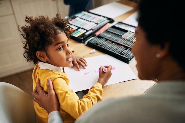Young girl and her mother coloring together at home during an ABA therapy session in Brandon, Florida